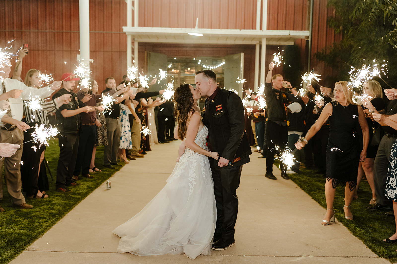 Couple kissing in sparkler exit at the red barn at schnepf farms