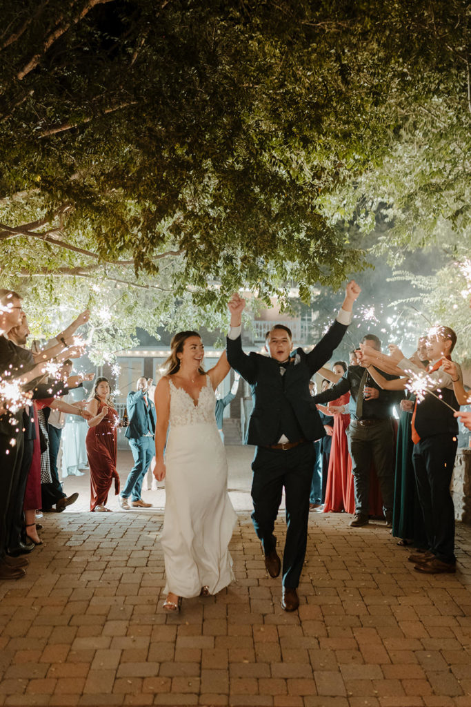 wedding couple cheering sparkler exit at stonebridge manor